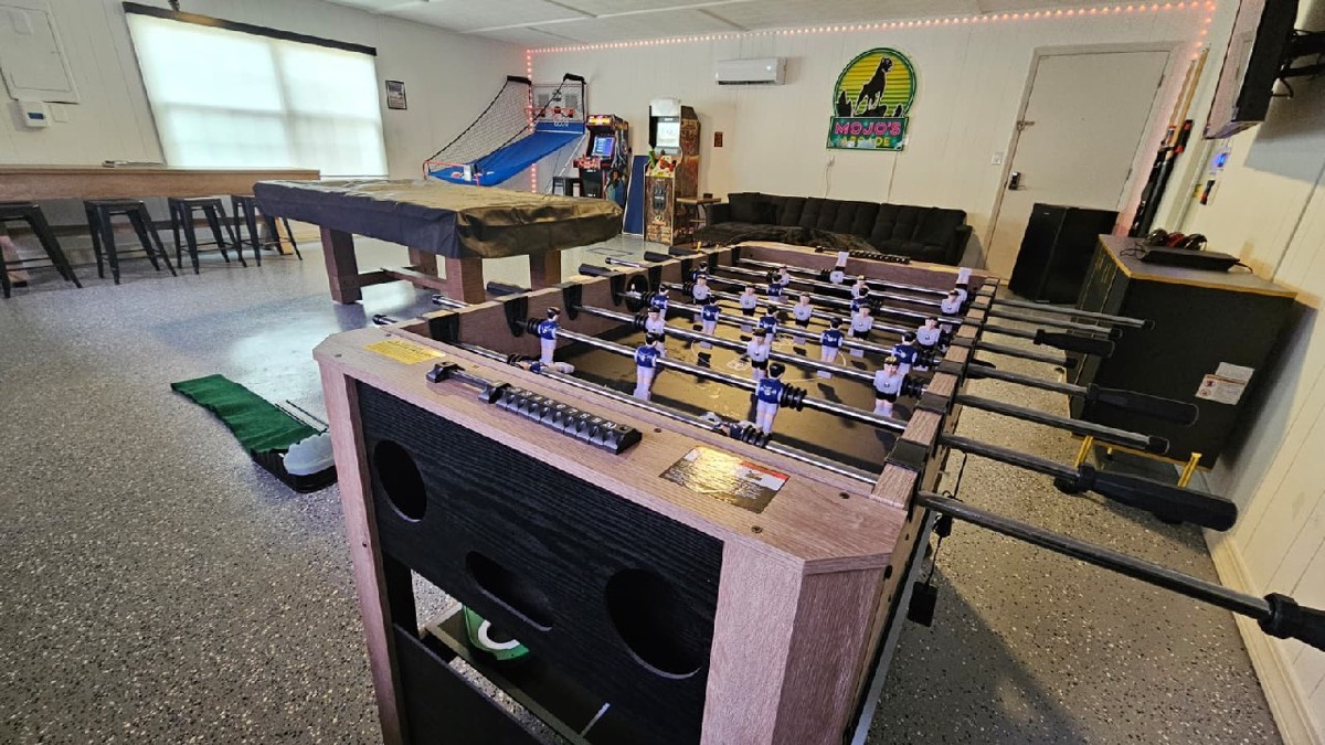 Mojo's Arcade game room with pool table and foosball at Mojo Manor